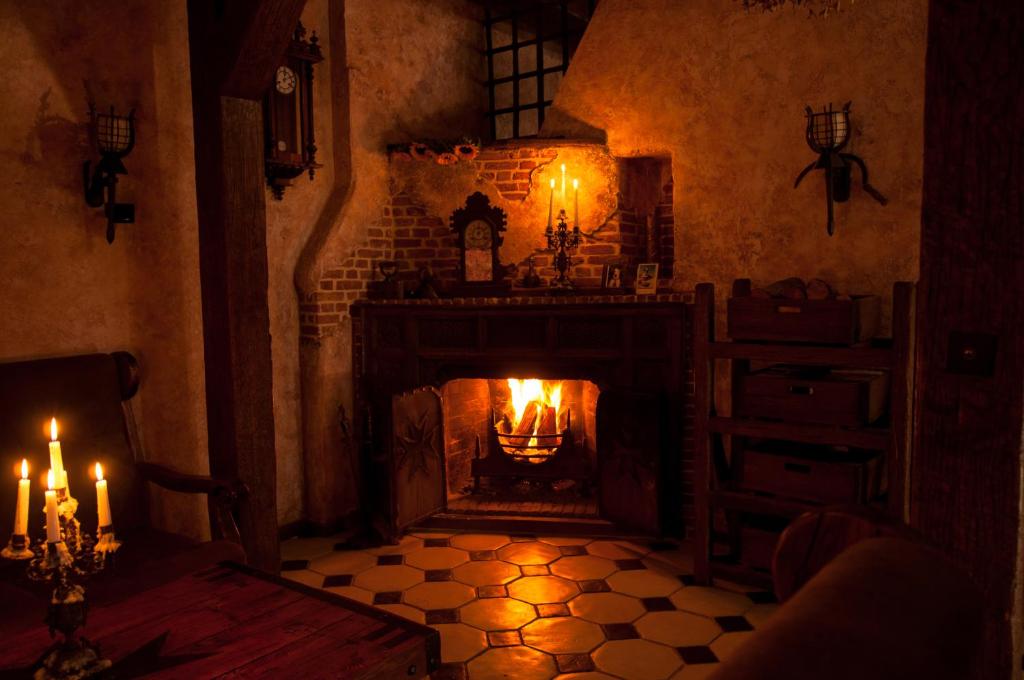 a room with a fireplace with candles in it at Attic Apartment Warszawa in Warsaw