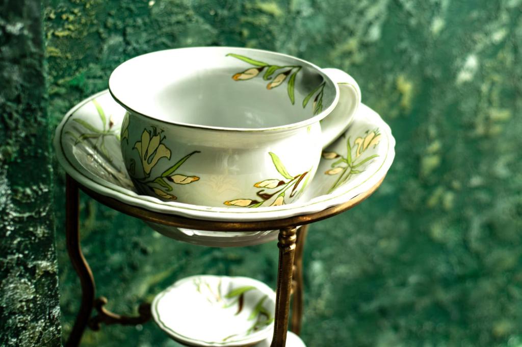 a tea cup and saucer on a stand at Attic Apartment Warszawa in Warsaw