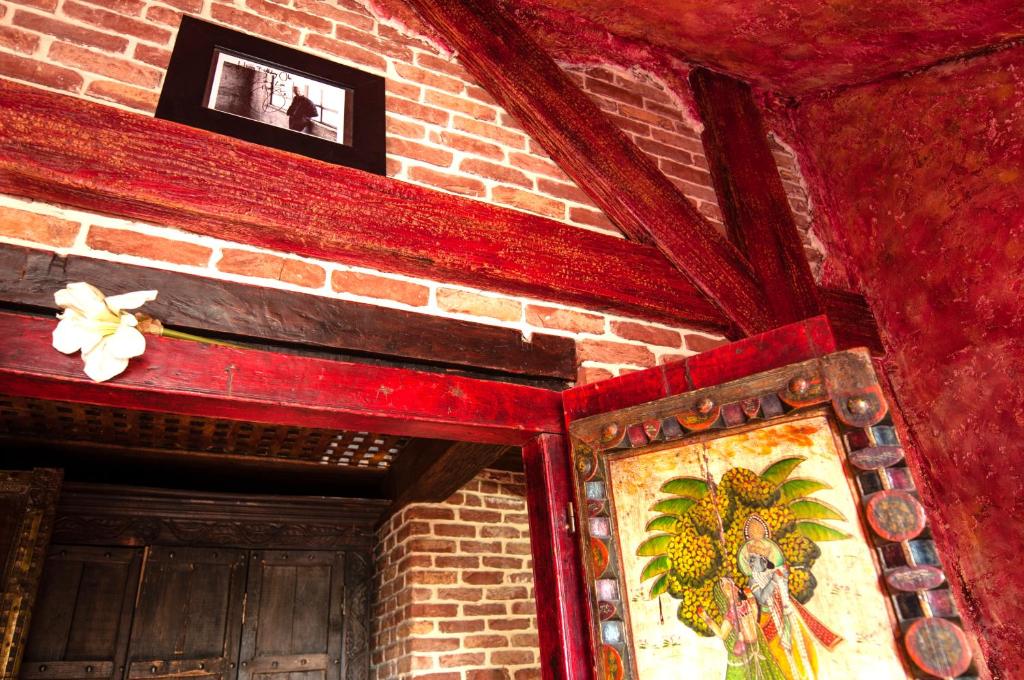 a room with a brick wall with a painting on it at Attic Apartment Warszawa in Warsaw