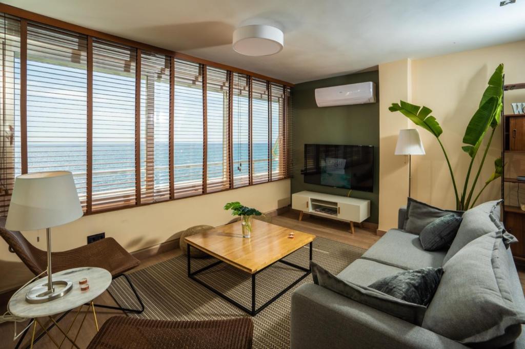 a living room with a couch and a television at Level 11 Apartment in Aguadulce