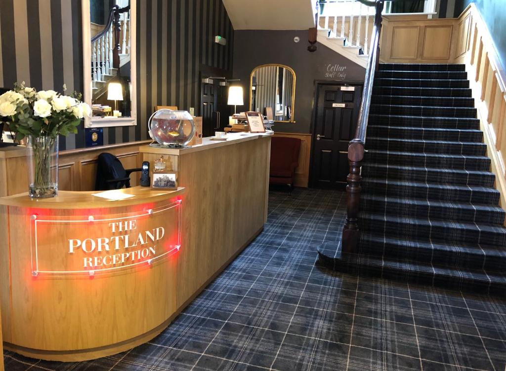 a restaurant with a sign that reads the portland reception at The Portland in Ashington