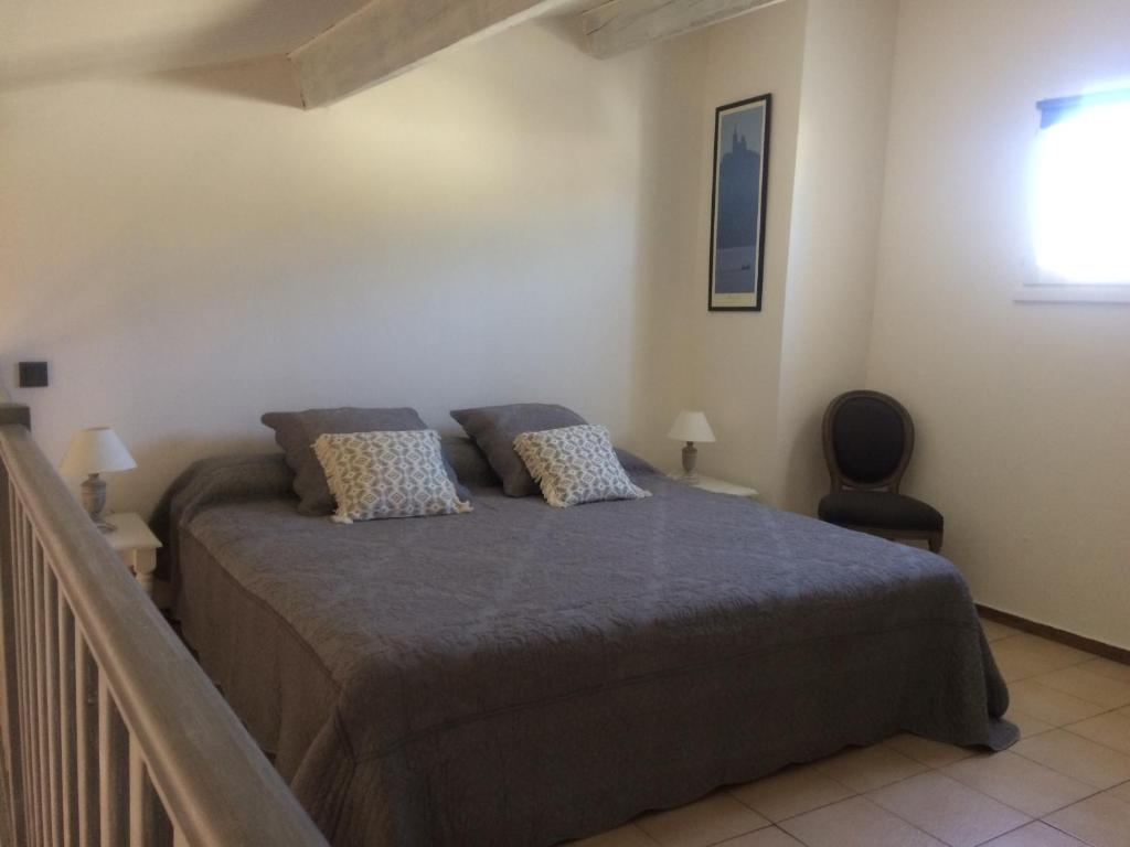 a bedroom with a bed with two pillows at Mer et Soleil in La Ciotat