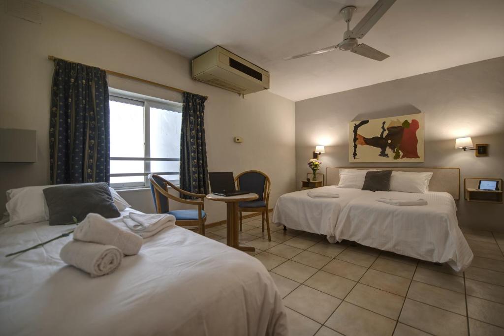Postel nebo postele na pokoji v ubytování Sliema Chalet Hotel