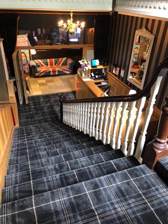 a staircase in a living room with a couch at The Portland in Ashington