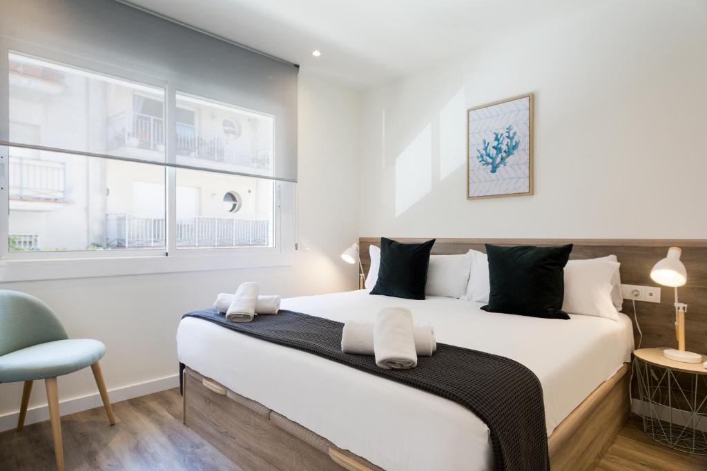 A bed or beds in a room at Sitges Group Calm Beach