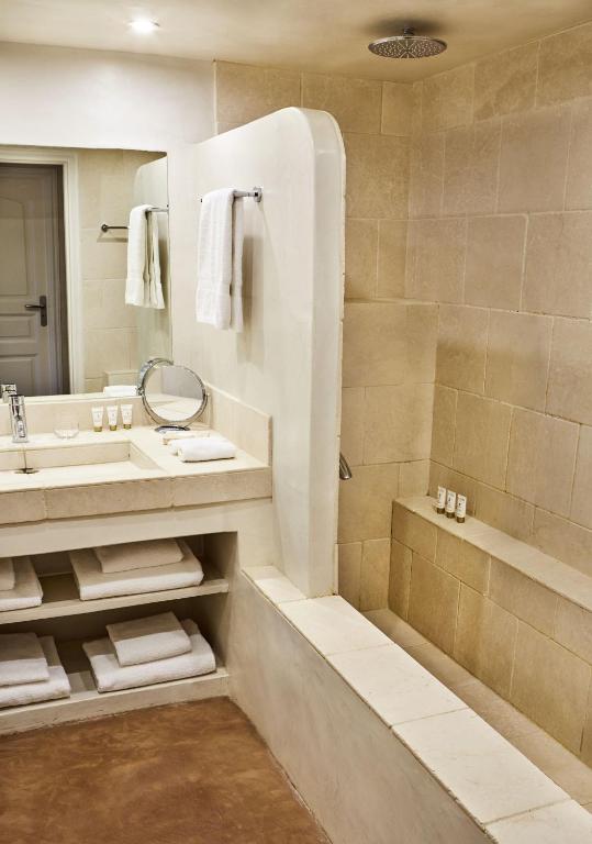 a bathroom with a sink and a tub and a mirror at Villa Cosy, hotel & spa in Saint-Tropez