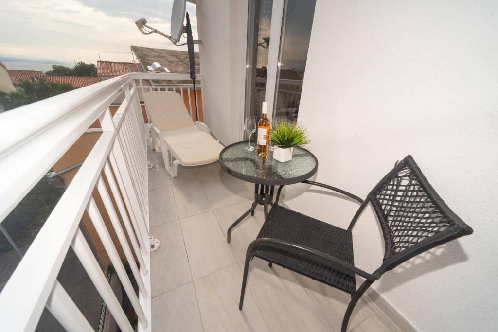 a small balcony with a table and a chair at Apartment Antonio in Baška Voda