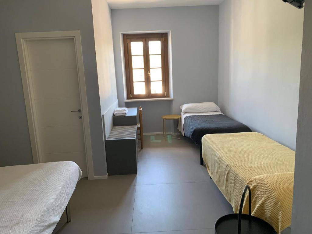 Postel nebo postele na pokoji v ubytování Locanda della Posta