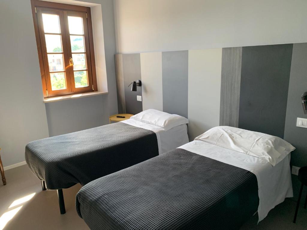 Postel nebo postele na pokoji v ubytování Locanda della Posta