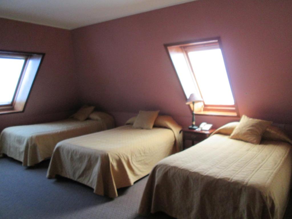 Postel nebo postele na pokoji v ubytování Hotel Apart Colón