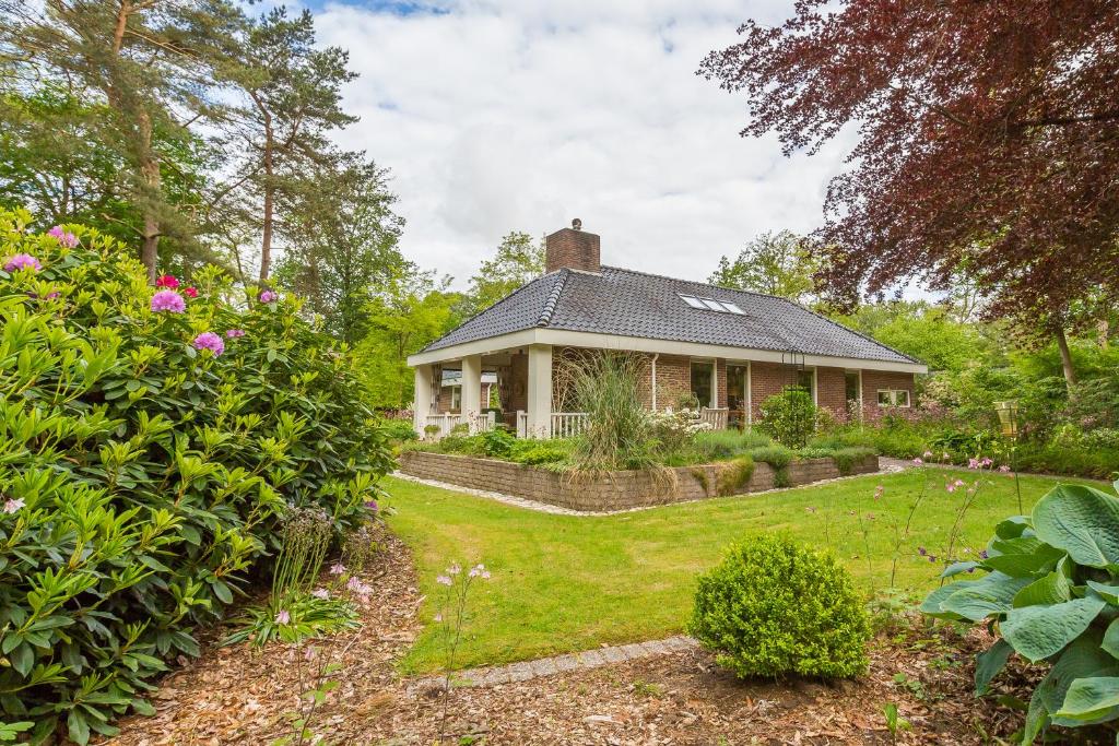 una casa con un jardín delante de ella en B&B Schipborg, en Zuidlaren