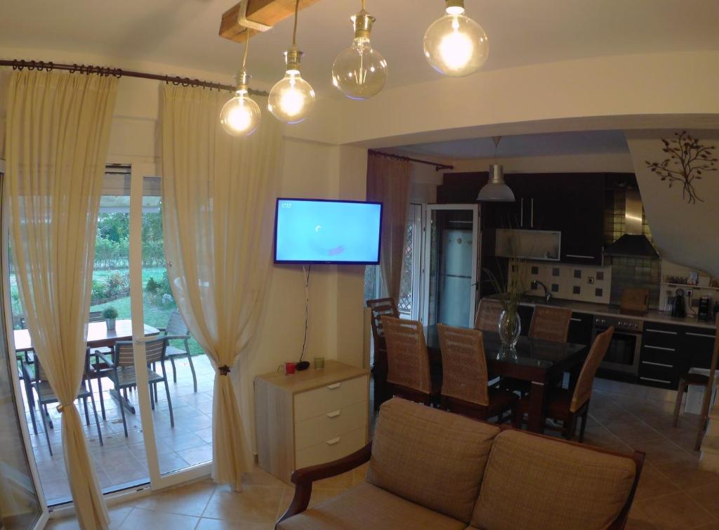 a living room with a couch and a dining room at Villa Evridiki in Fourka