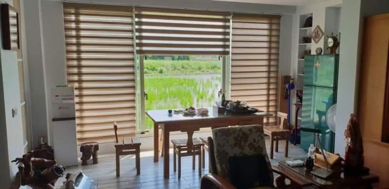 a kitchen with a table and chairs and a large window at JiuZhiAn Apartment in Wujie