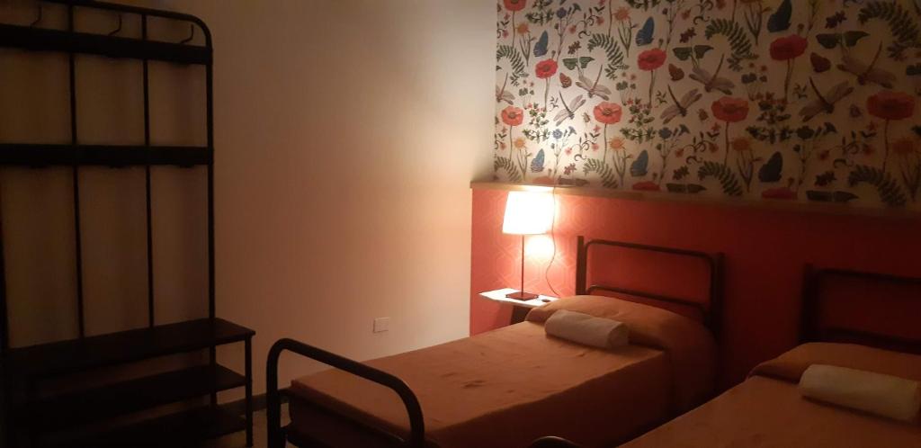 Postel nebo postele na pokoji v ubytování Ostello Tasso