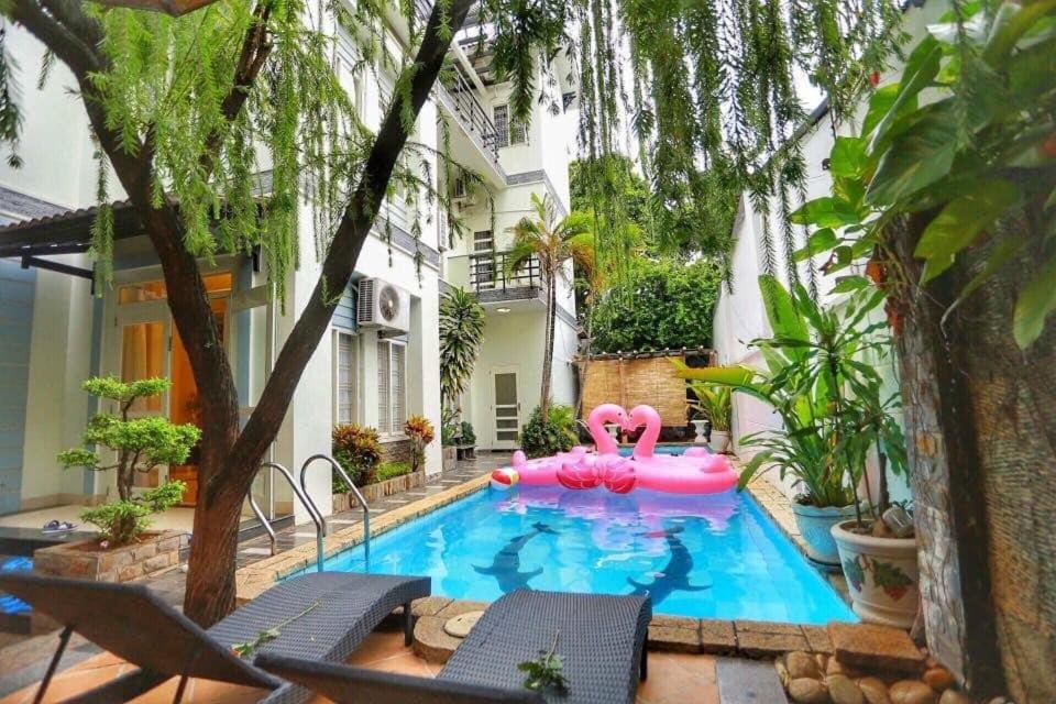 a swimming pool with pink inflatables in a backyard at Sea Villa - 22 Bà Triệu in Vung Tau