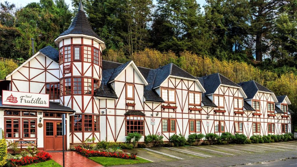 a building with a tower on top of it at Hotel Frutillar in Frutillar