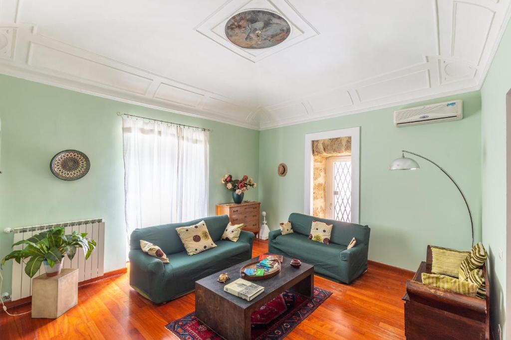 a living room with two blue couches and a coffee table at Casa Professa Luxury Palermo Center in Palermo