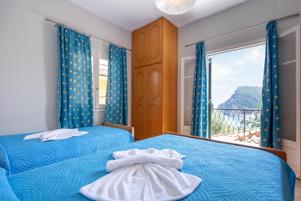 Postel nebo postele na pokoji v ubytování Rapanos Apartments