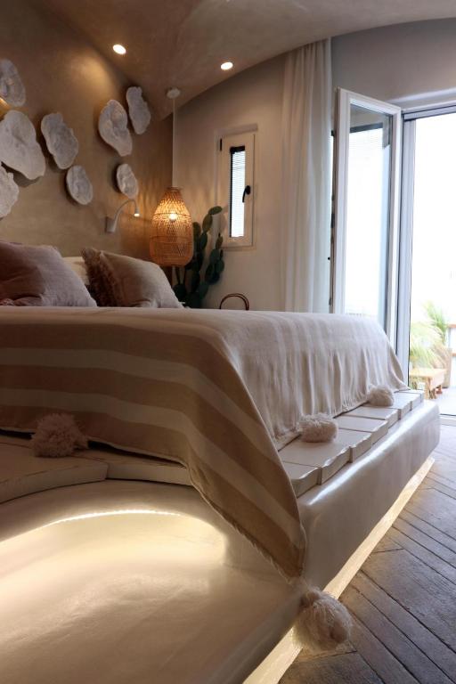 A bed or beds in a room at Narcissus Luxury Suites