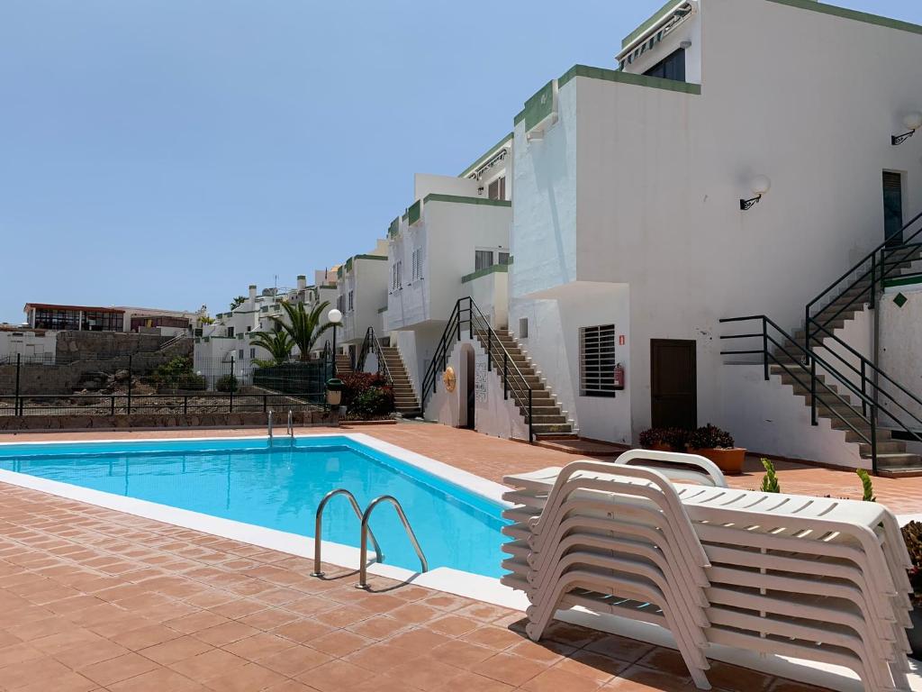a swimming pool in front of a building at Casa di Luca EL VERGEL by luca properties gran canaria in Puerto Rico de Gran Canaria