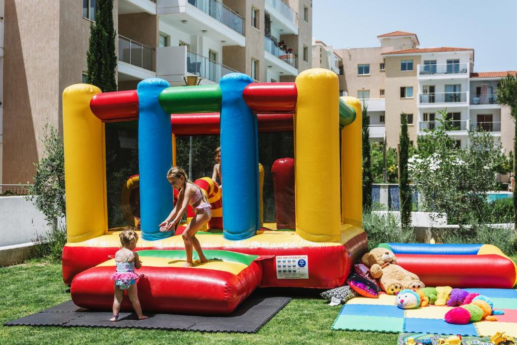 a woman and a child playing on a inflatable playground at Elysia Park in Paphos
