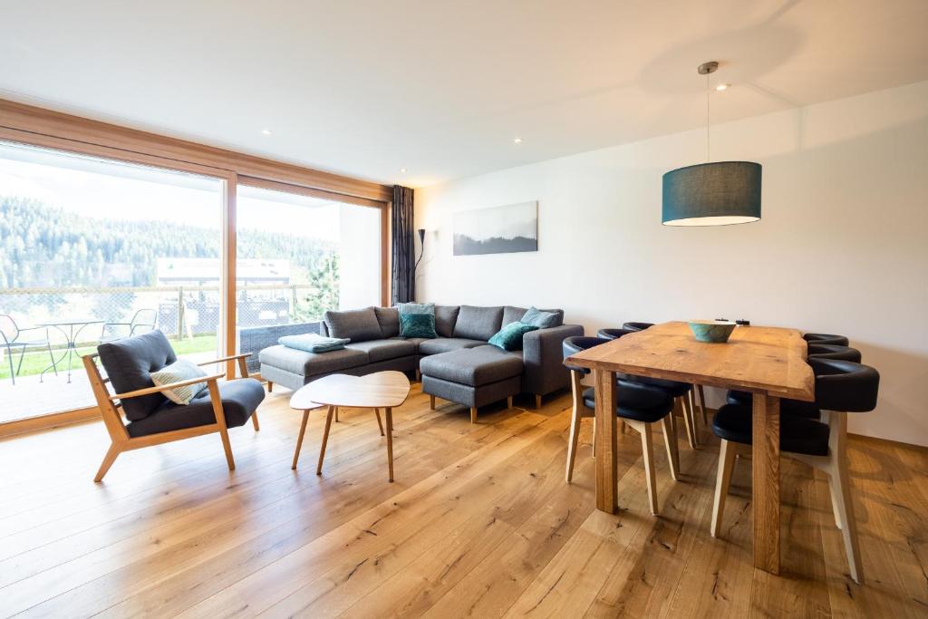 a living room with a couch and a table at Casa Miraselva in Flims