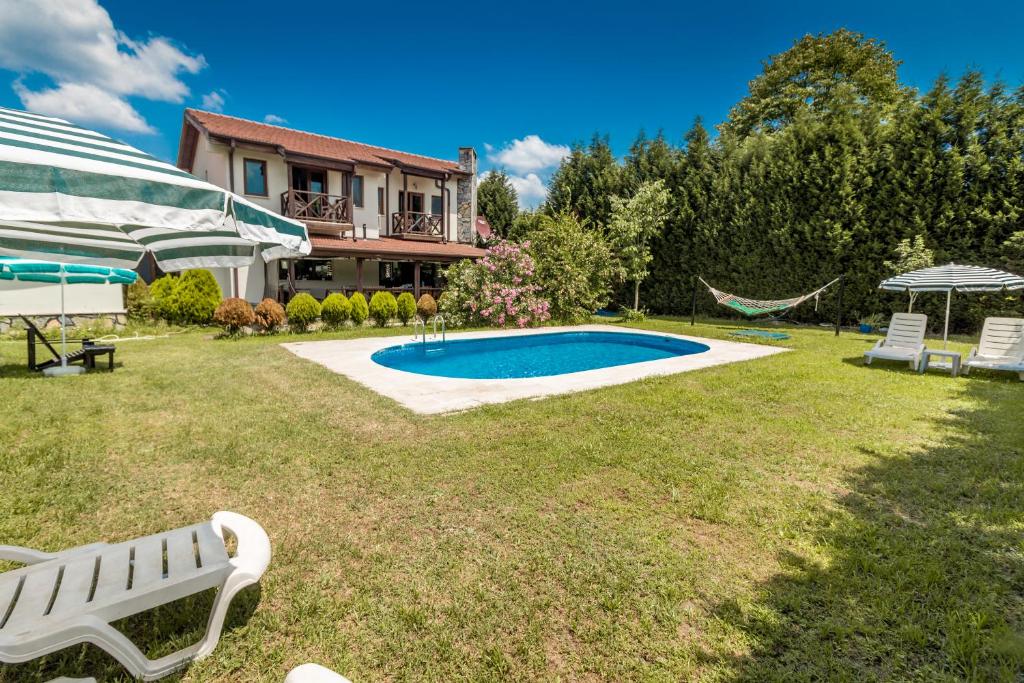 a yard with a swimming pool and a house at MyHomeSapanca in Sapanca