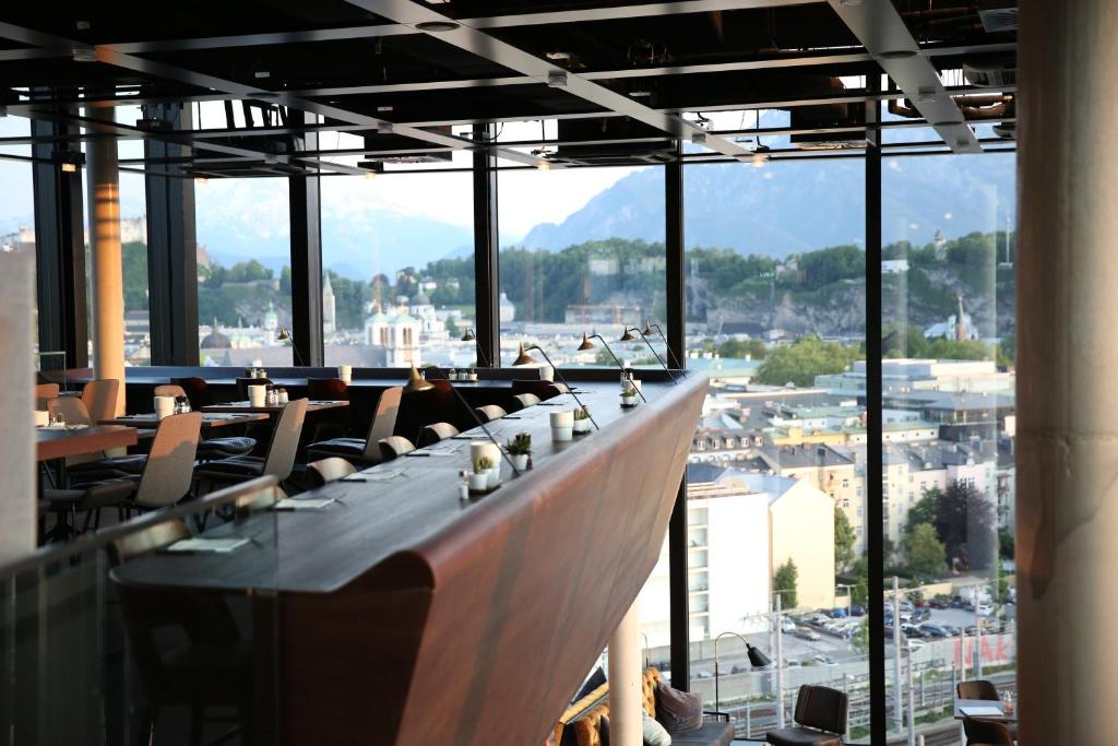 a long table in a room with a view of a city at arte Hotel Salzburg in Salzburg