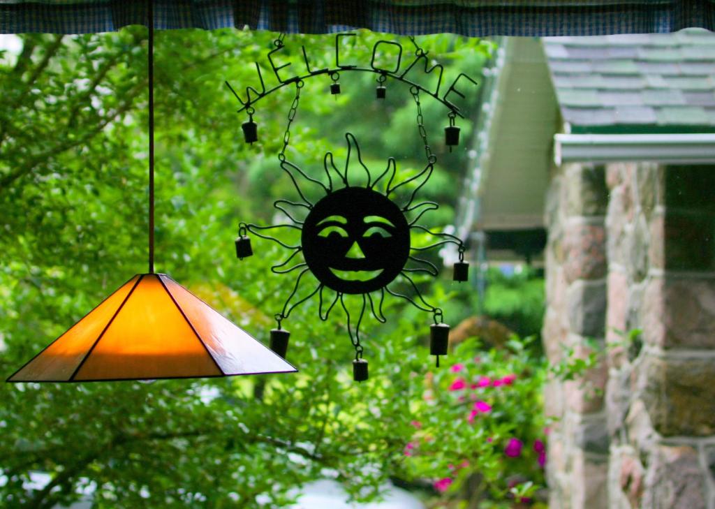 a lamp with a face drawn on a window at Auberge Le Lupin-Self Check-in in Mont-Tremblant