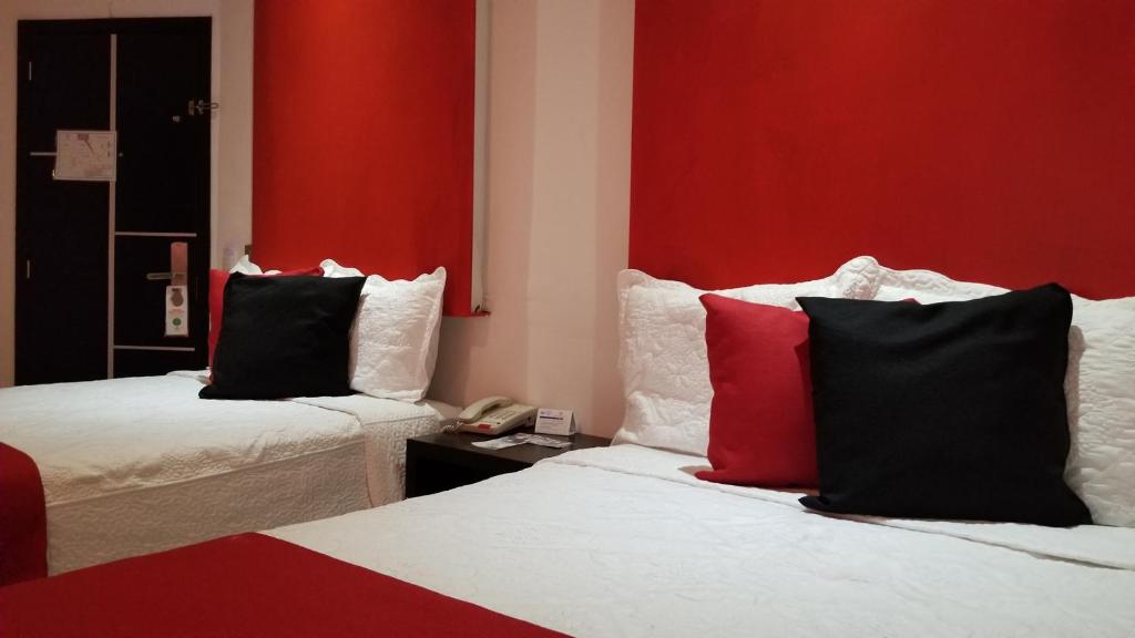 Postel nebo postele na pokoji v ubytování Hotel Dluxe