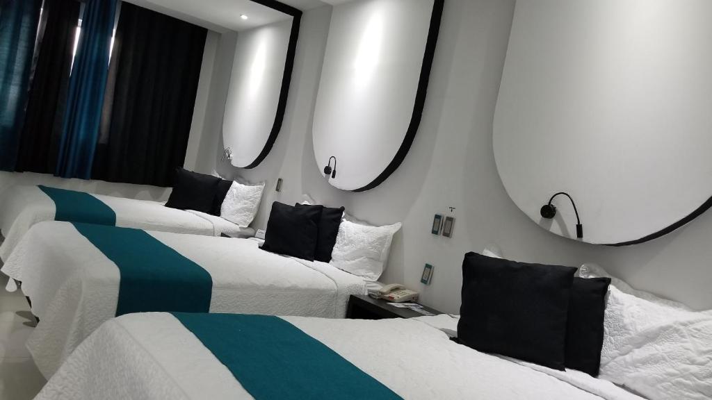 Postel nebo postele na pokoji v ubytování Hotel Dluxe