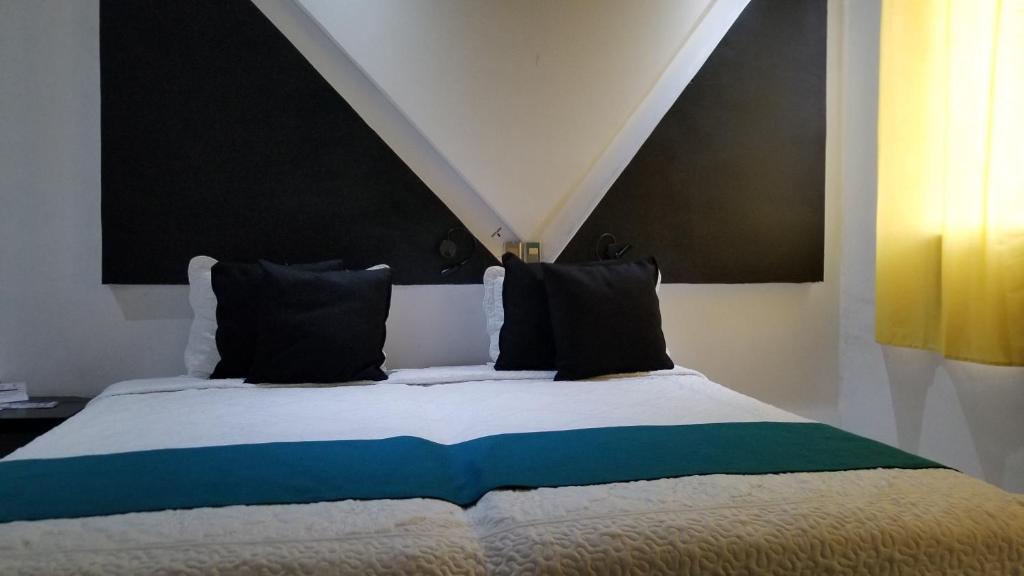 Postel nebo postele na pokoji v ubytování Hotel Dluxe