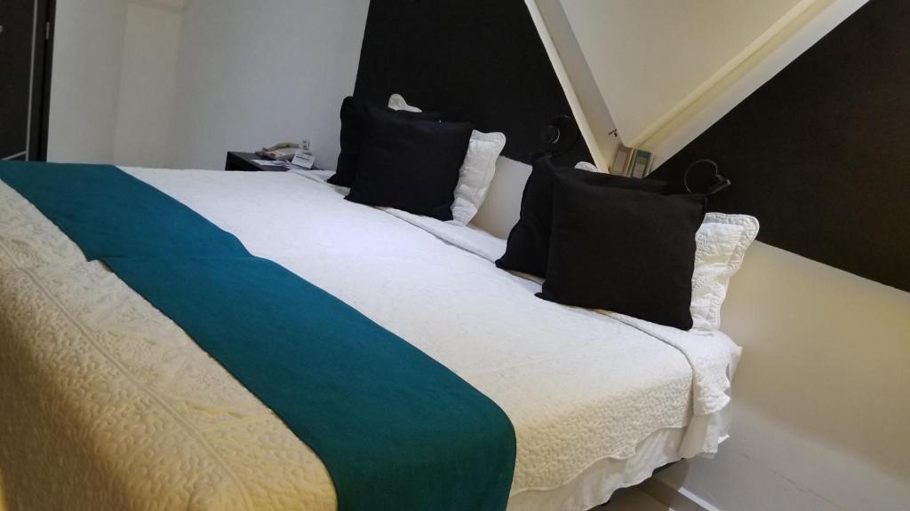 Een bed of bedden in een kamer bij Hotel Dluxe