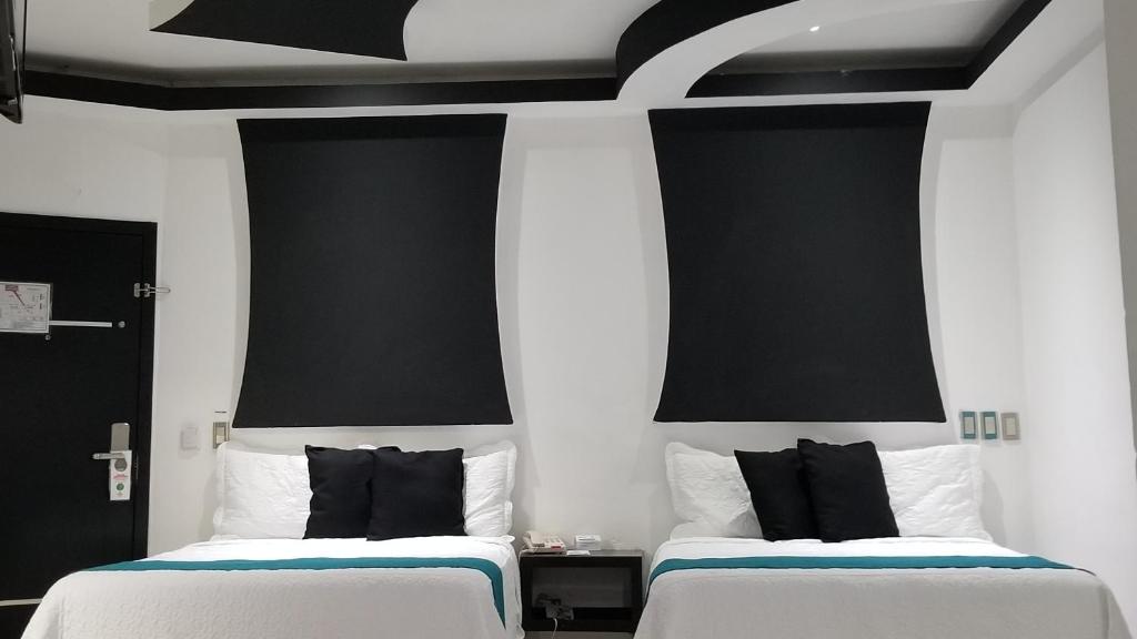 Postel nebo postele na pokoji v ubytování Hotel Dluxe