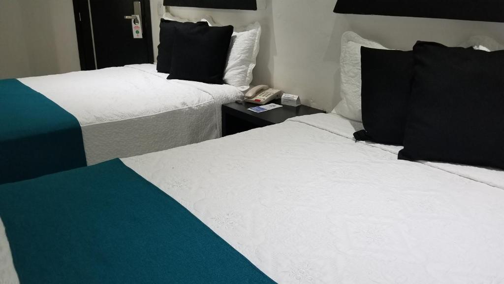 Postel nebo postele na pokoji v ubytování Hotel Dluxe