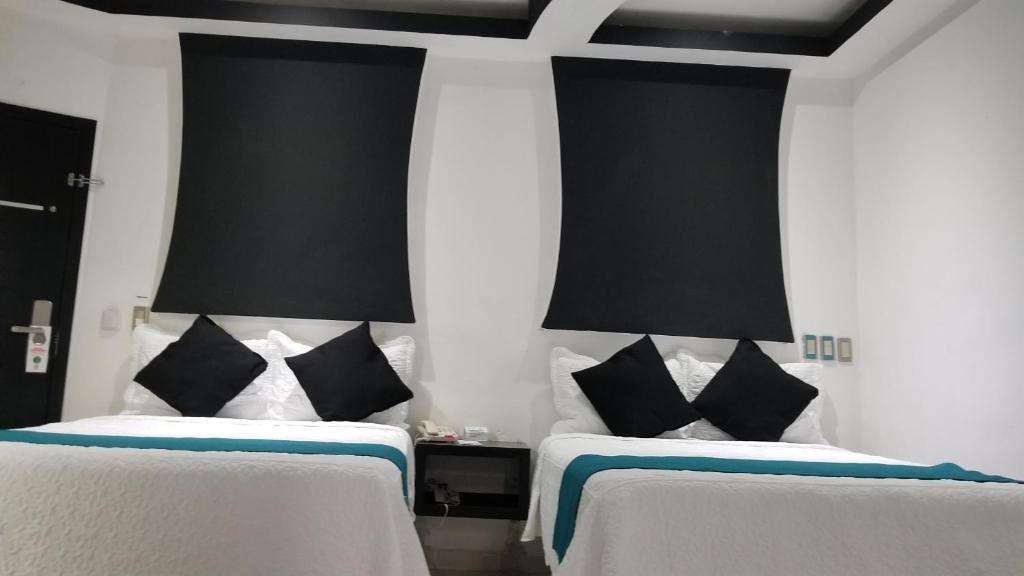 Postel nebo postele na pokoji v ubytování Hotel Dluxe