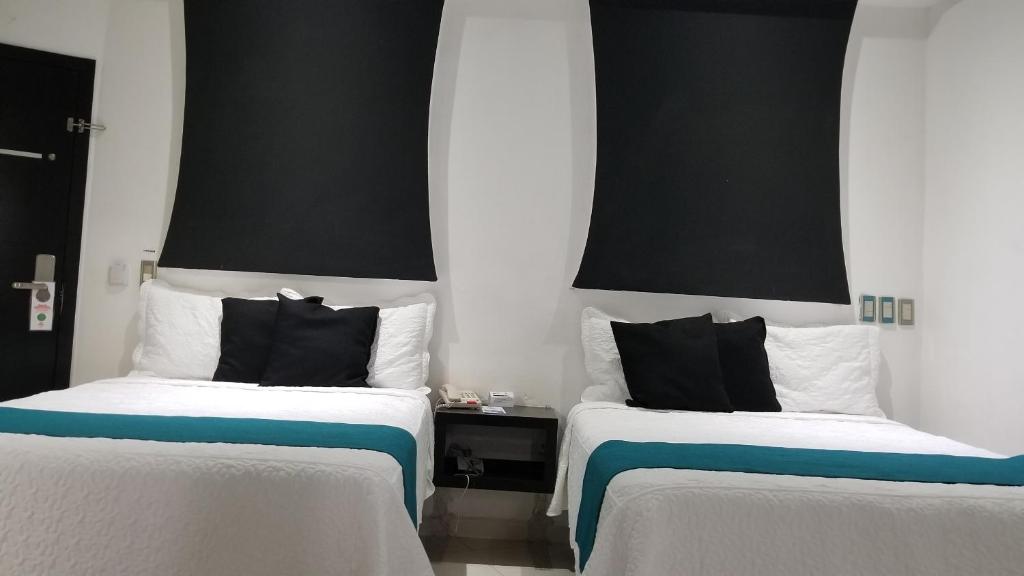 Postel nebo postele na pokoji v ubytování Hotel Dluxe