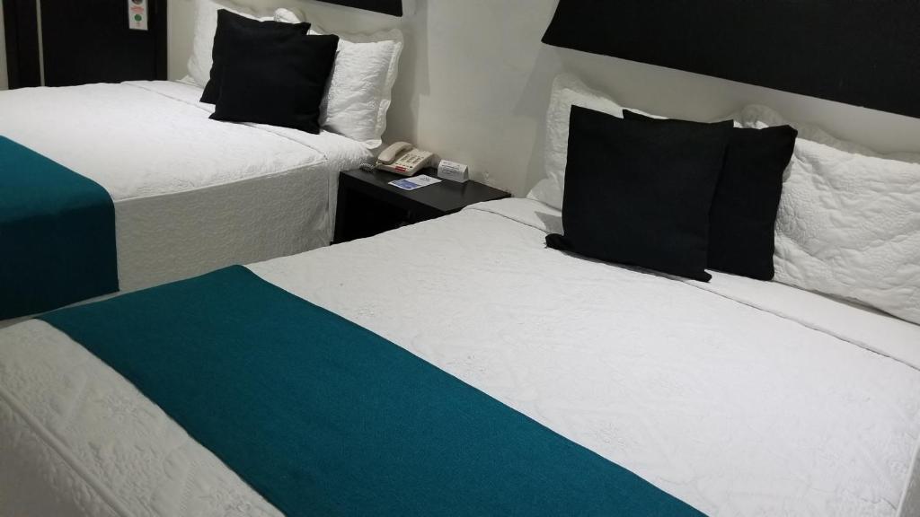 Postel nebo postele na pokoji v ubytování Hotel Dluxe