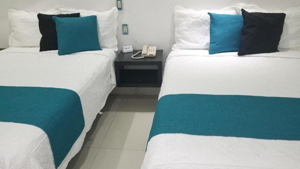 Postel nebo postele na pokoji v ubytování Hotel Dluxe