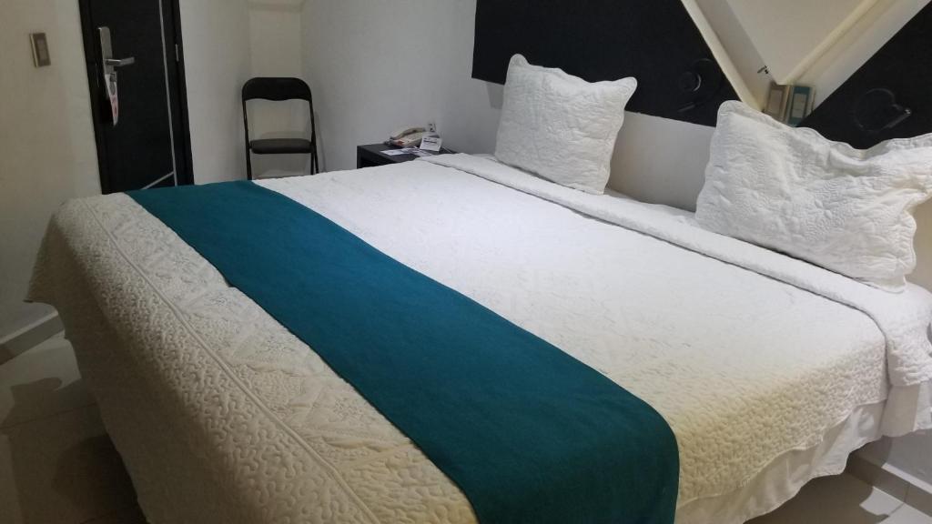 Postel nebo postele na pokoji v ubytování Hotel Dluxe