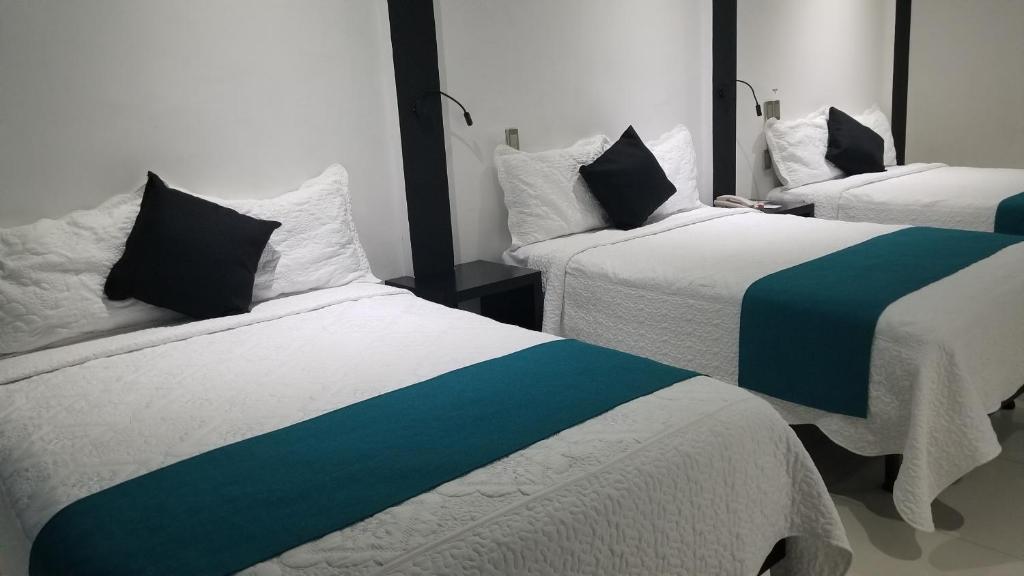 Postel nebo postele na pokoji v ubytování Hotel Dluxe
