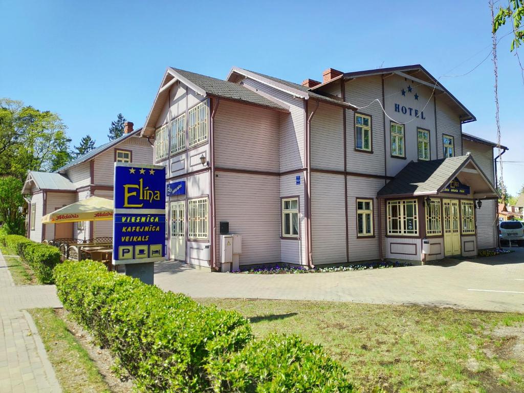 a building with a sign in front of it at Elīna in Jūrmala