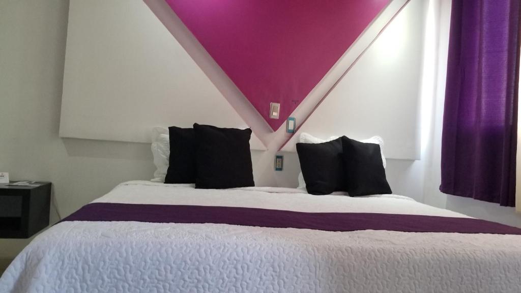 Postel nebo postele na pokoji v ubytování Hotel Dluxe