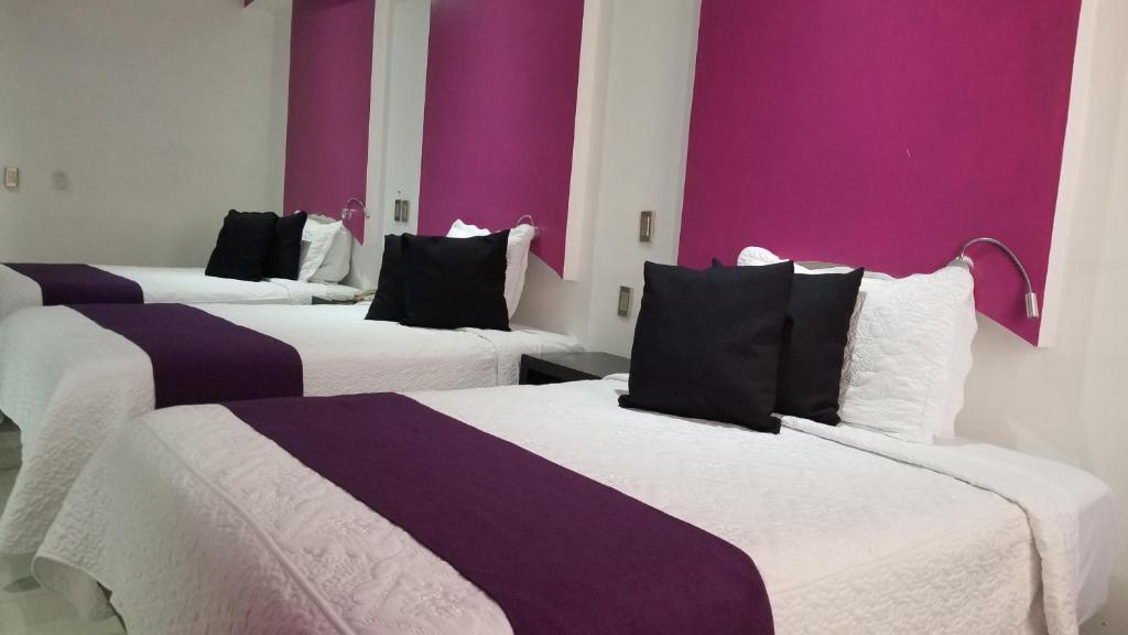 Postel nebo postele na pokoji v ubytování Hotel Dluxe