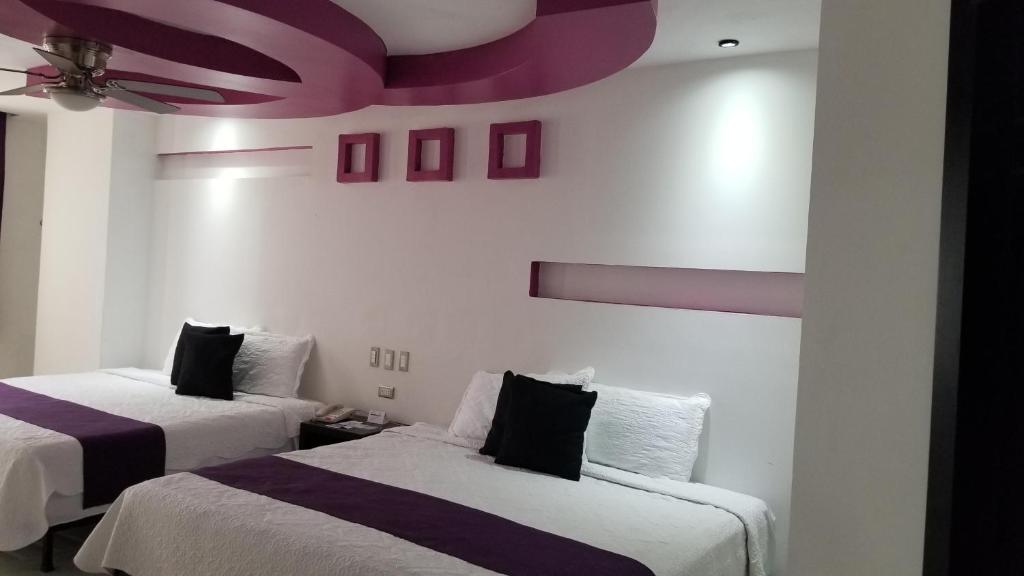 Postel nebo postele na pokoji v ubytování Hotel Dluxe