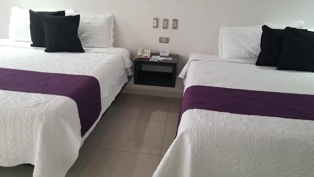 Postel nebo postele na pokoji v ubytování Hotel Dluxe