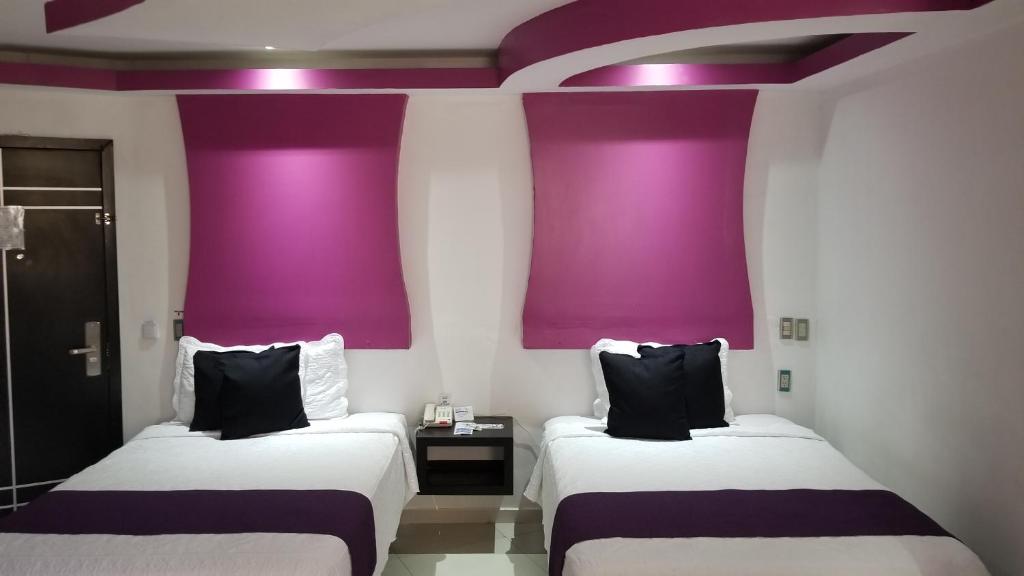 Postel nebo postele na pokoji v ubytování Hotel Dluxe