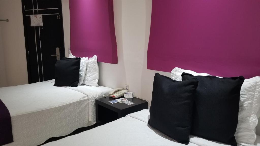Postel nebo postele na pokoji v ubytování Hotel Dluxe