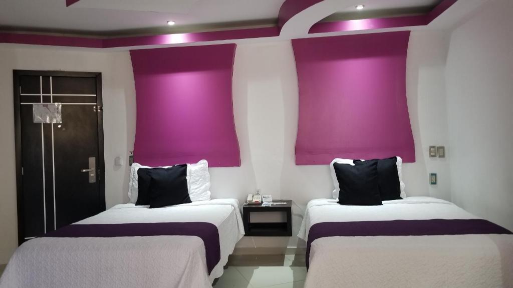 Postel nebo postele na pokoji v ubytování Hotel Dluxe