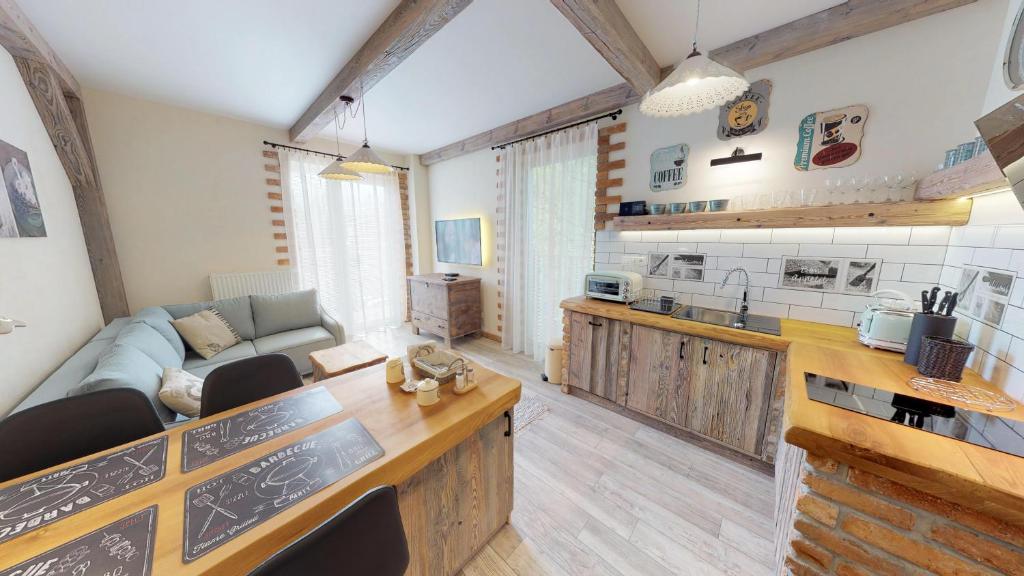 a kitchen and living room with a couch and a table at Apartmán Sofia s infrasaunou, PRIMO, Starý Smokovec in Smokovce